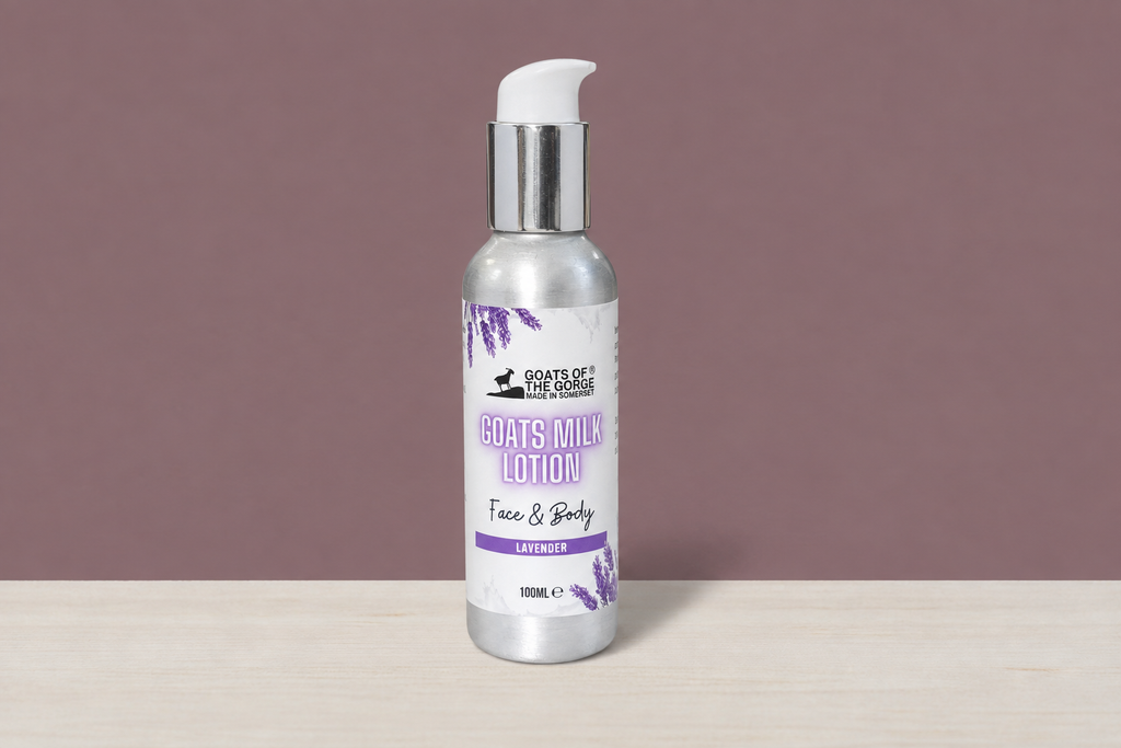 Lavender Goats of the Gorge lotion bottle in the mauve wall and wood table scene