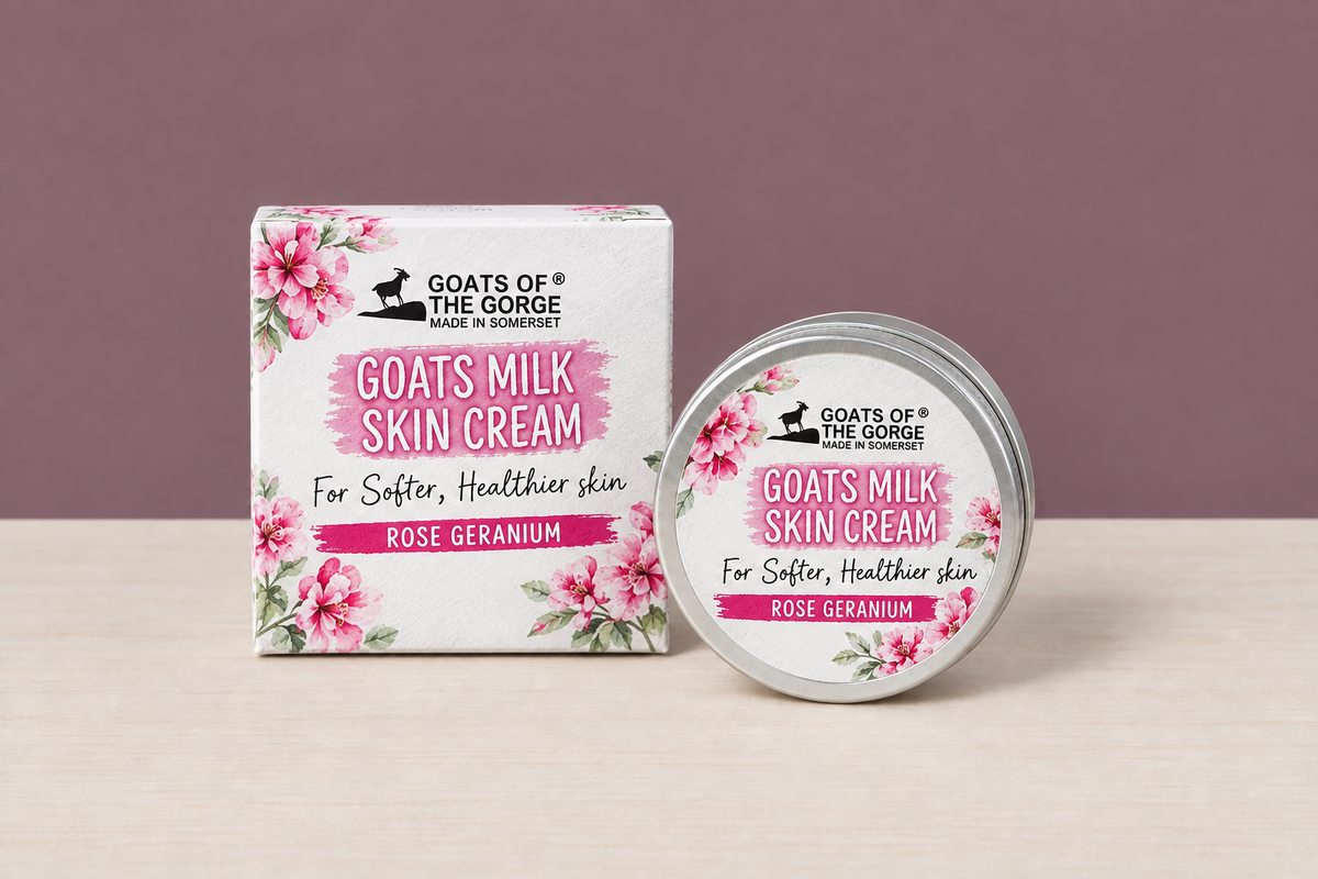 Rose Geranium Goats Milk Skin Cream box and tin in the mauve wall and wood table scene